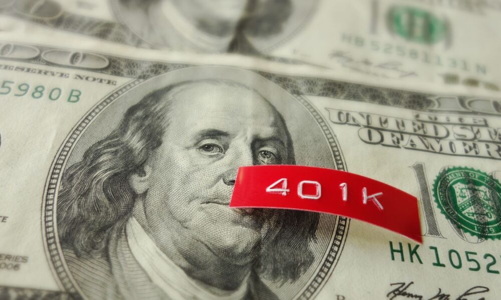 A red label printed 401K on top of a hundred dollar bill