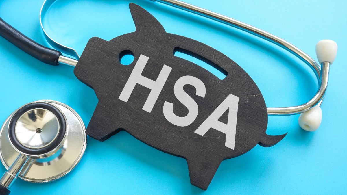 A black wooden pig that says HSA on it next to a stethoscope